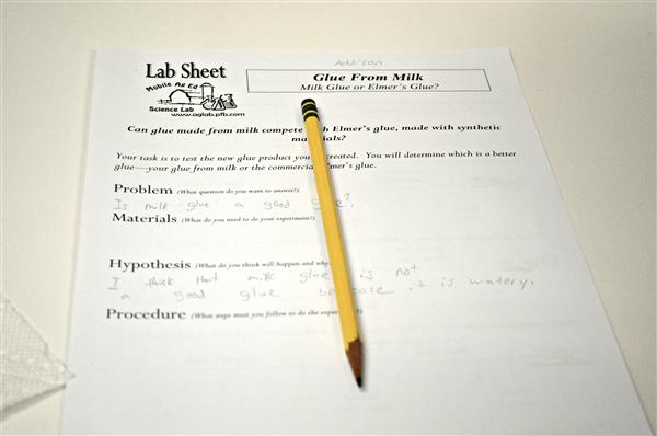 Picture of lab sheet that asks if glue made from milk and complete with synthetic glue 